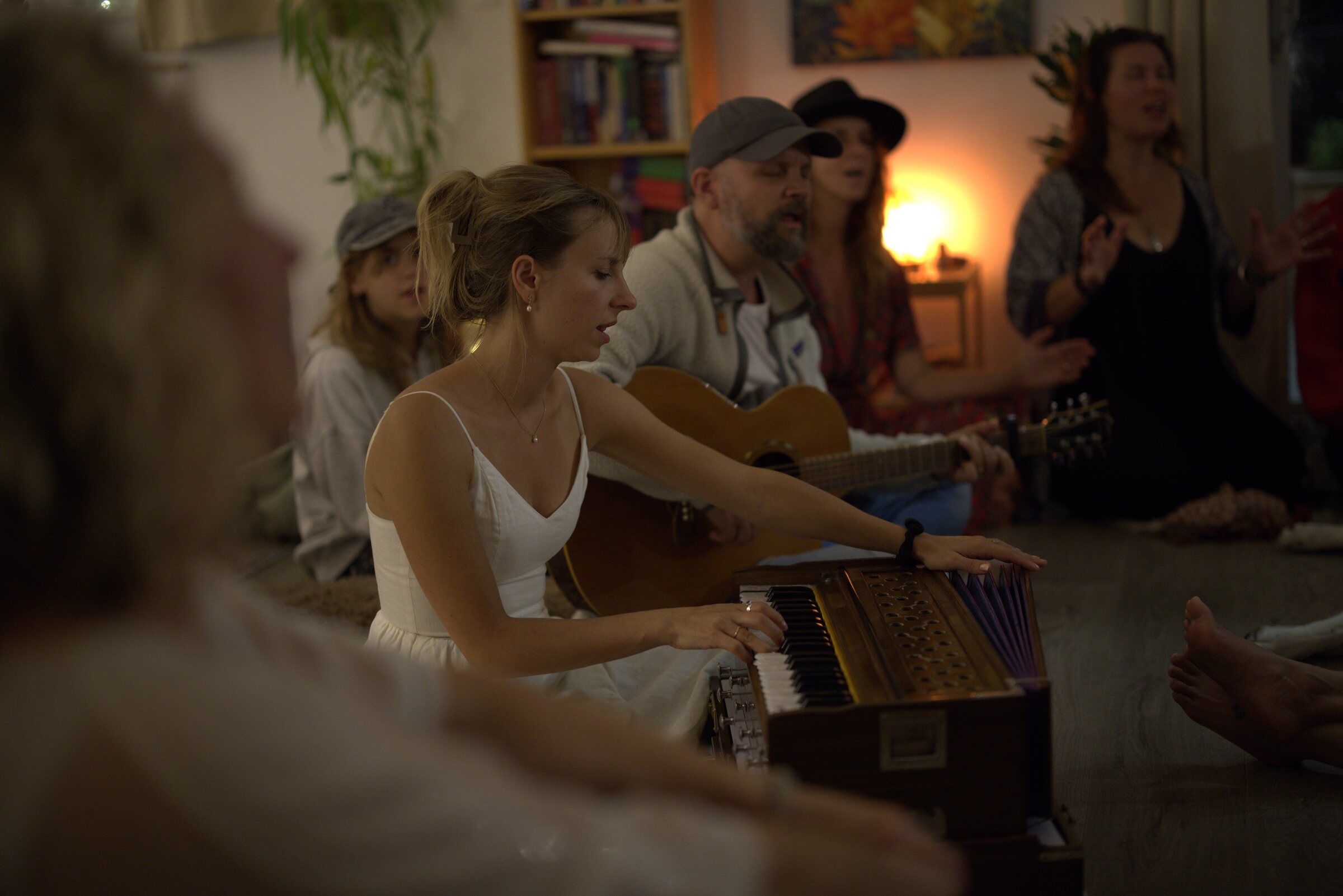 Tatiana and Mark leading kirtan with harmonium and guitar