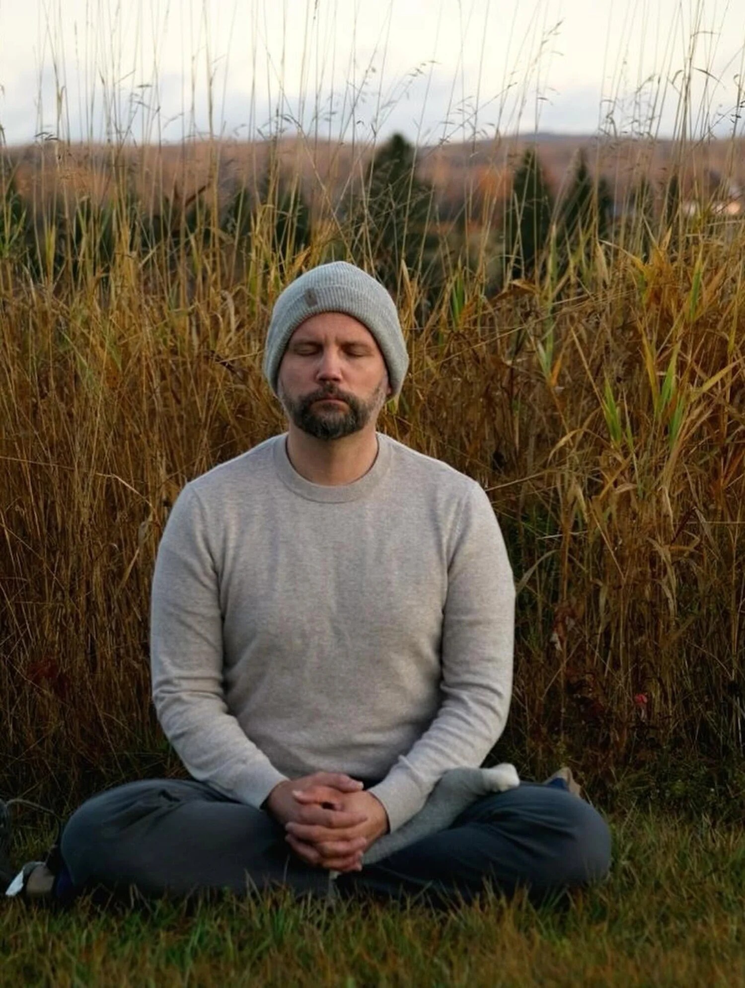 Mark Benson seated in meditation outdoors